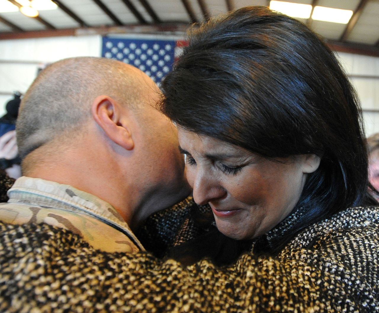 Haley hugs her husband after his Army National Guard unit returned in 2013. Michael Haley was deployed in Afghanistan for a year. He was part of an agricultural team that trained Afghan farmers how to turn their poppy crops into food crops.