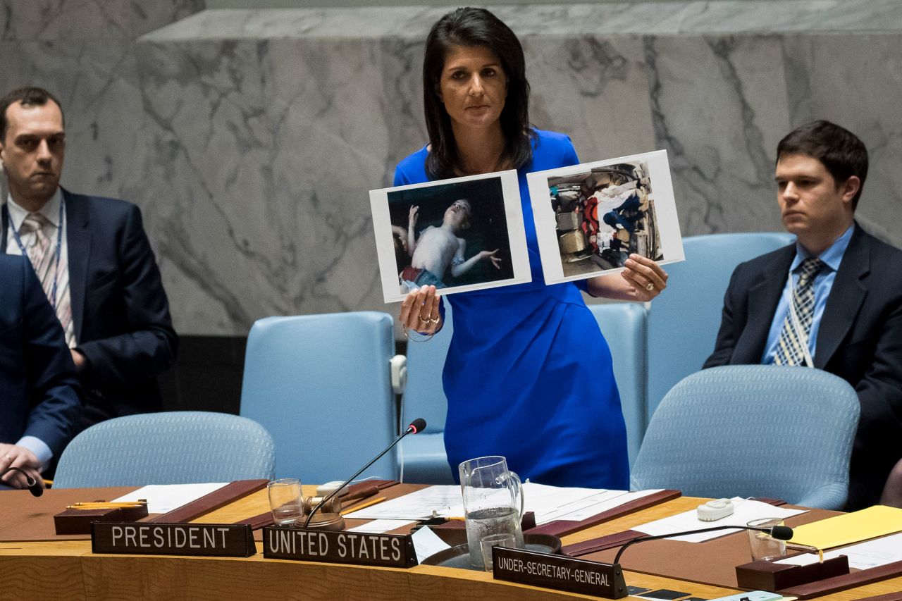 Haley holds up photos of victims of a Syrian chemical attack during a meeting of the United Nations Security Council in April 2017.