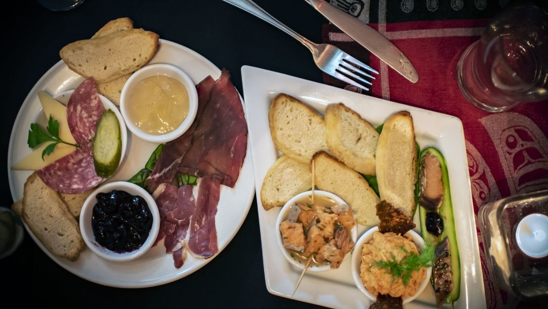 Wild game charcuterie and salmon prepared three ways are served as appetizers with toasted bannock.