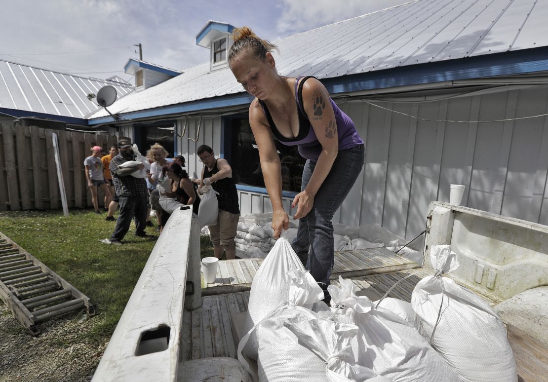 Krystal Day, of Homosassa, Fla., leads a sandbag assembly line at the Old Port Cove restaurant on Tuesday in Ozello, Fla. 