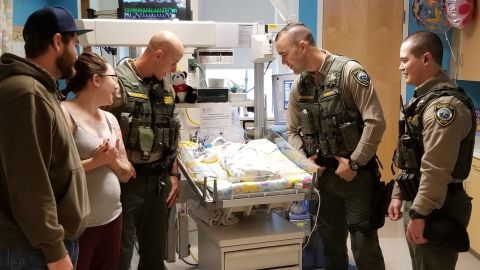 Clackamas County Sheriff's Office Deputies Zacharkiw, Olson and Russell reunite with Audrey and her parents.