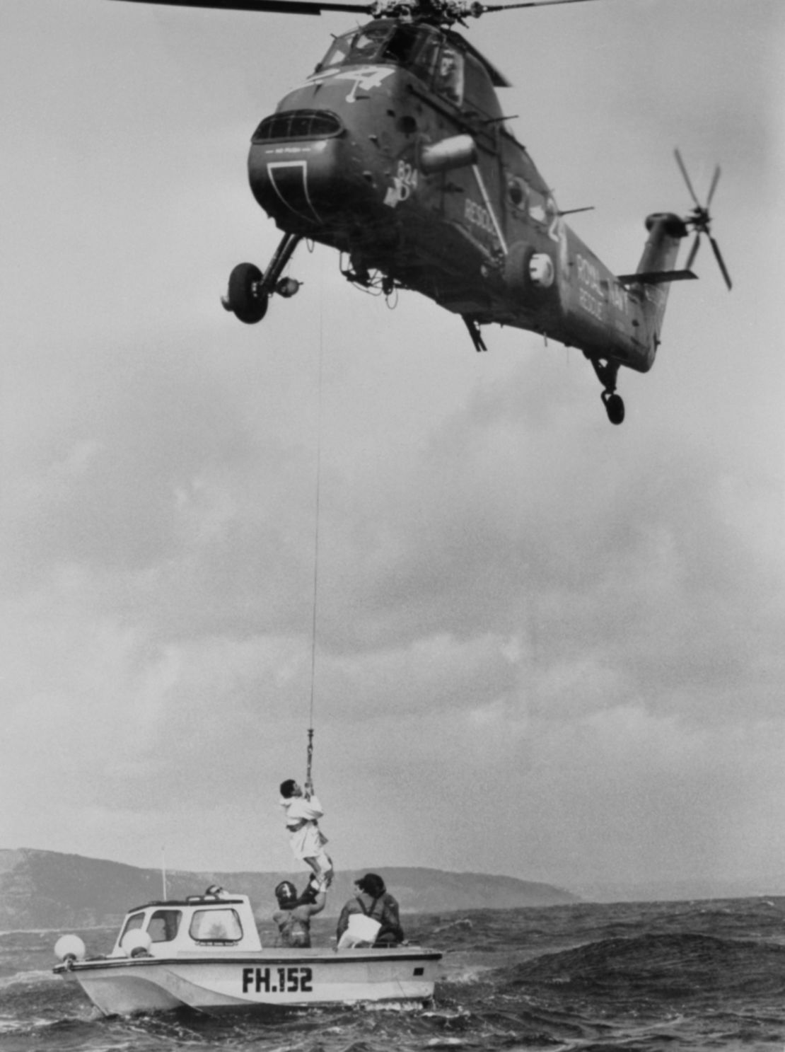 Le Bon being winched up by a naval helicopter.