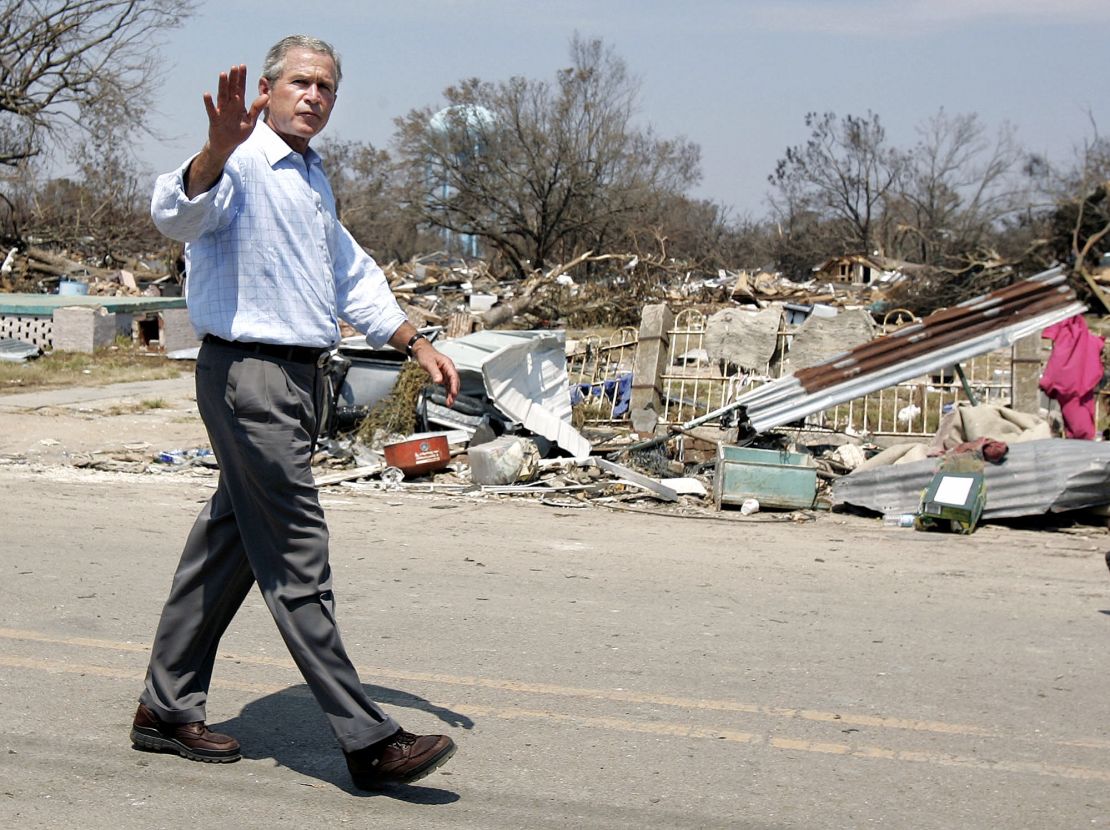 President Bush waves as he takes a walking tour of Biloxi, Mississippi, after Hurricane Katrina on September 2, 2005.