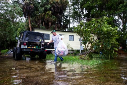 Mitchell Pope tries to salvage what he can from his mobile home in St. Marks.