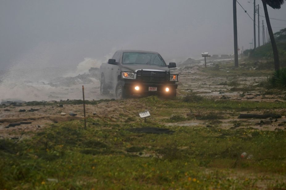 A truck drives along a road in Alligator Point, Florida, that had been washed out by the storm on October 10.