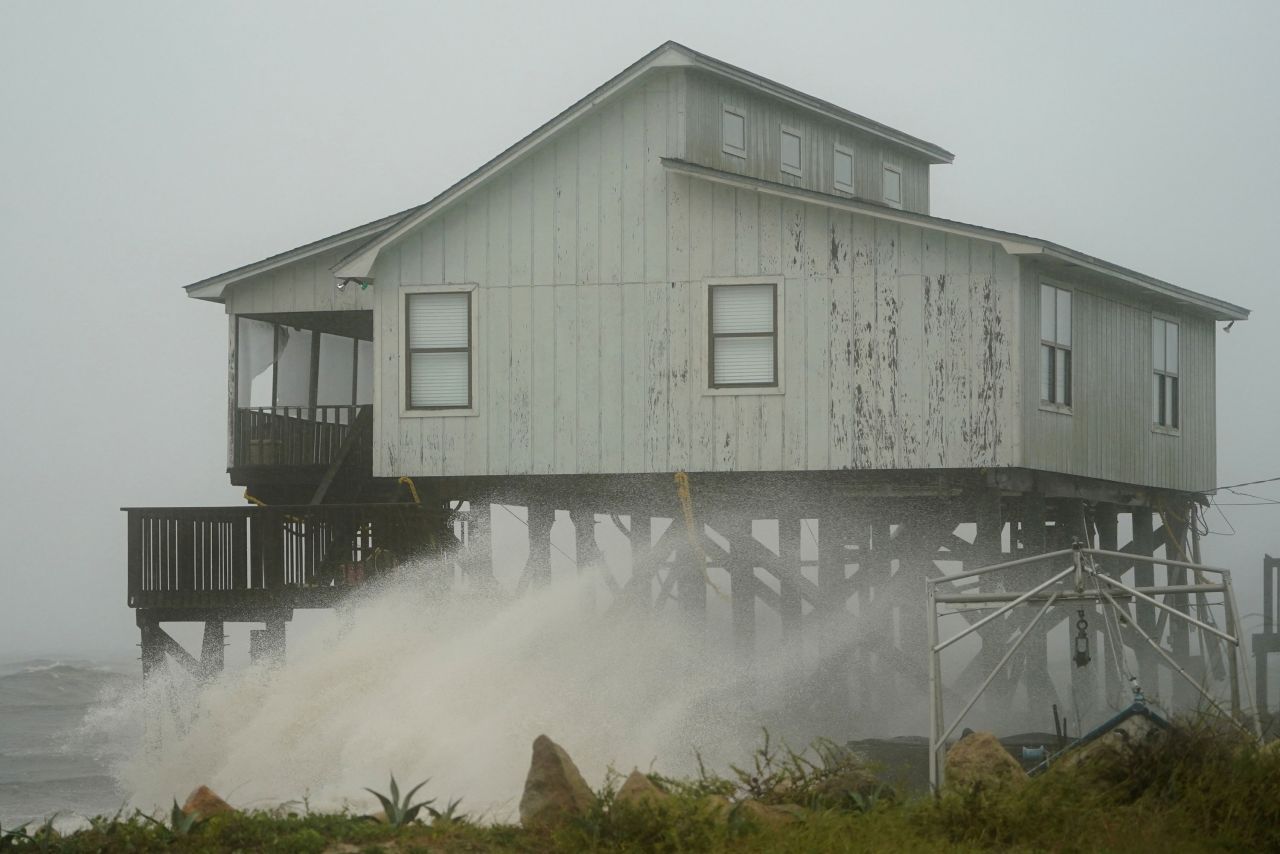 Waves hit a house in Alligator Point on October 10.