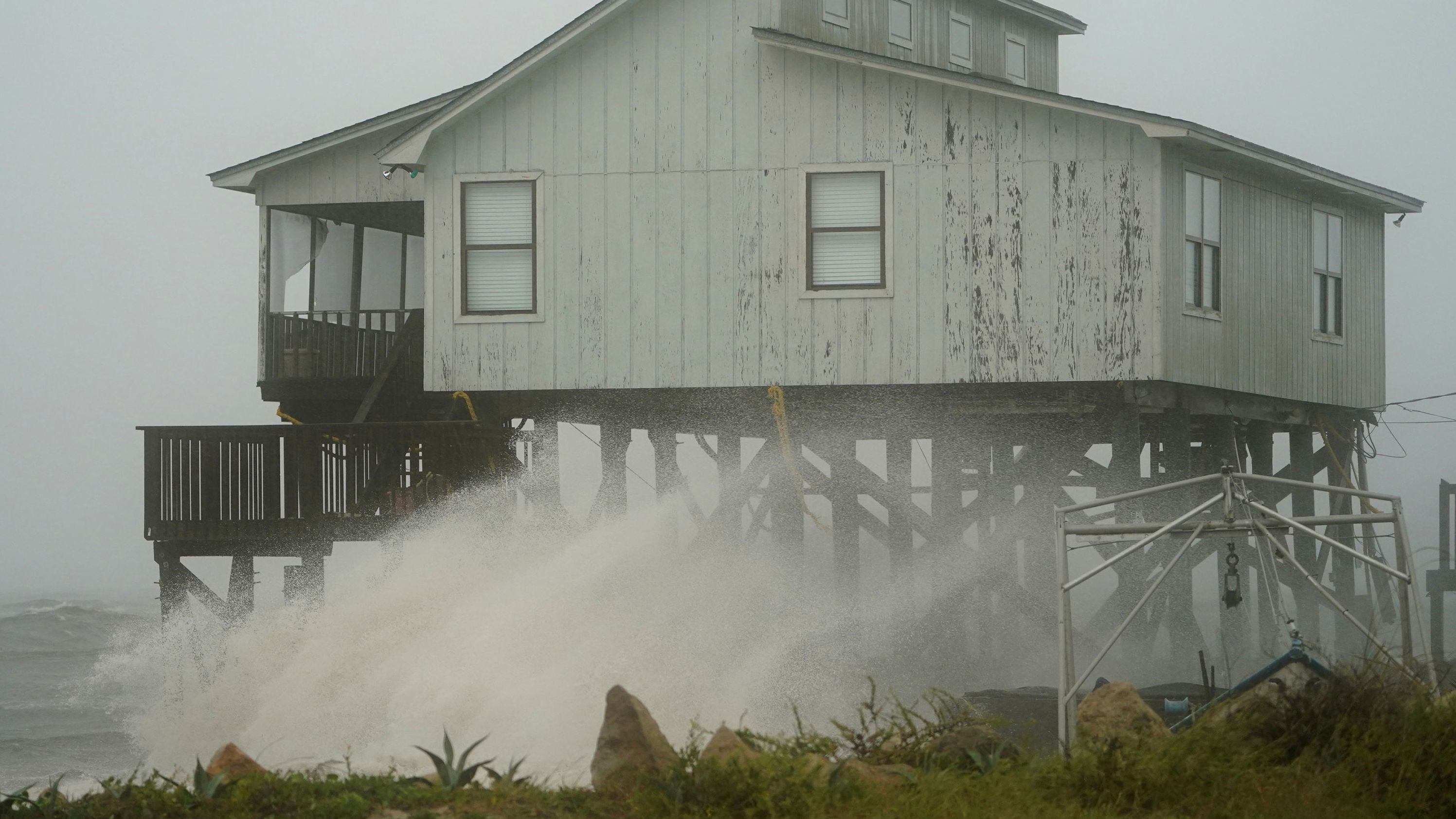 Waves hit a house in Alligator Point on October 10.