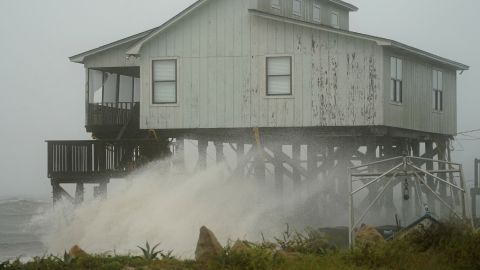 Waves sweep over a house as the storm comes ashore Wednesday in Alligator Point. 