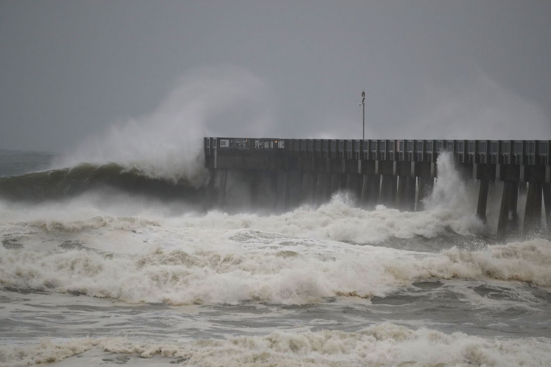 Waves crash along a pier as the outerbands of  hurricane Michael arrived in Panama City Beach, Florida. 