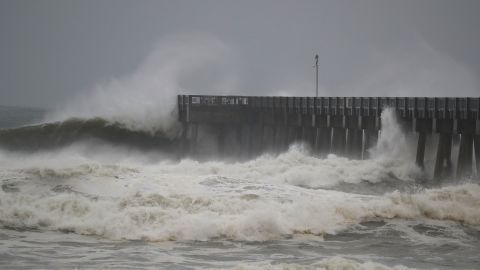 Waves crash along a pier as the outerbands of hurricane Michael arrived in Panama City Beach, Florida.