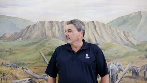 Todd Nelson, owner of Kalahari Resorts and Conventions, stands in front of a mural of the African wilderness at his water park in Wisconsin Dells, Wisconsin.