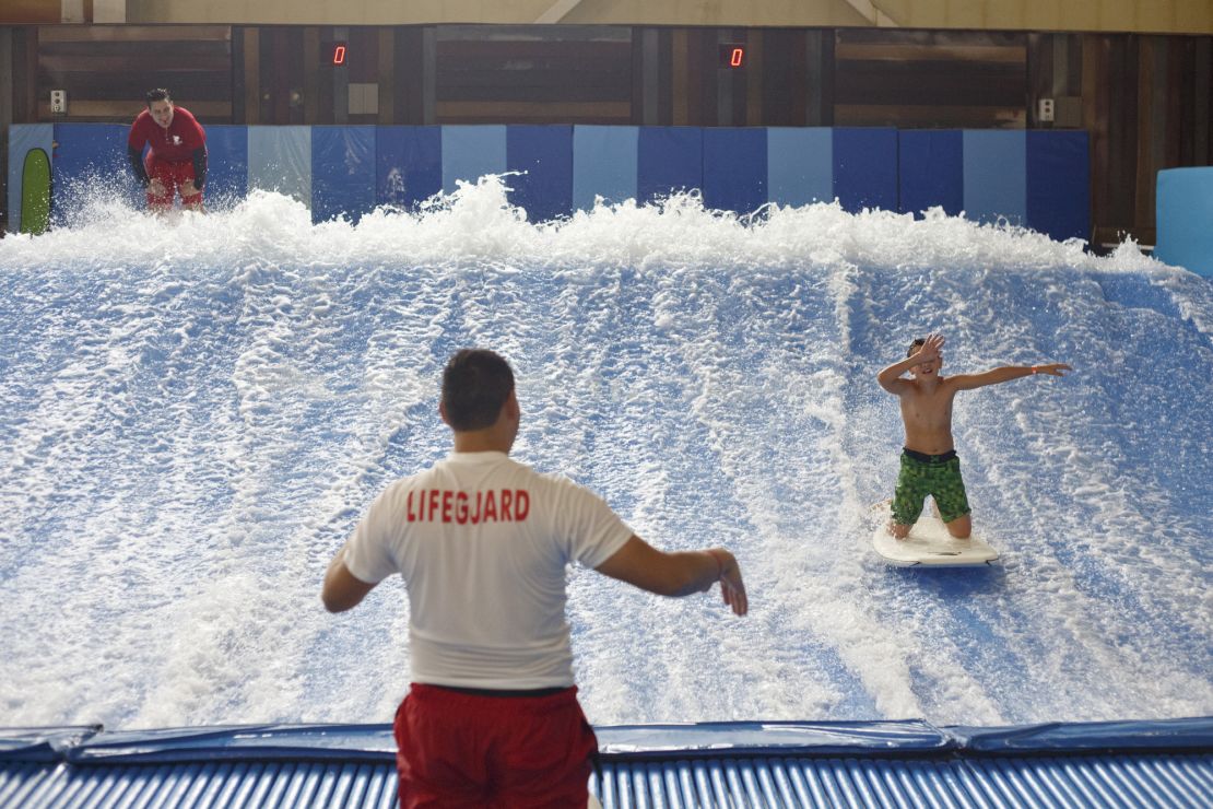 A boy rides the Flowrider, a surfing simulator at Kalahari's water park in Wisconsin Dells, Wisconsin.