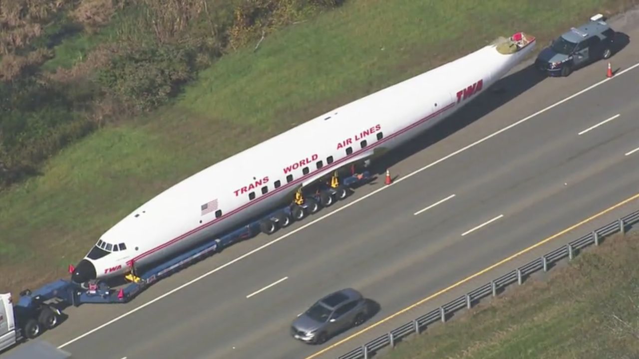 Vintage TWA airliner travels down the highway