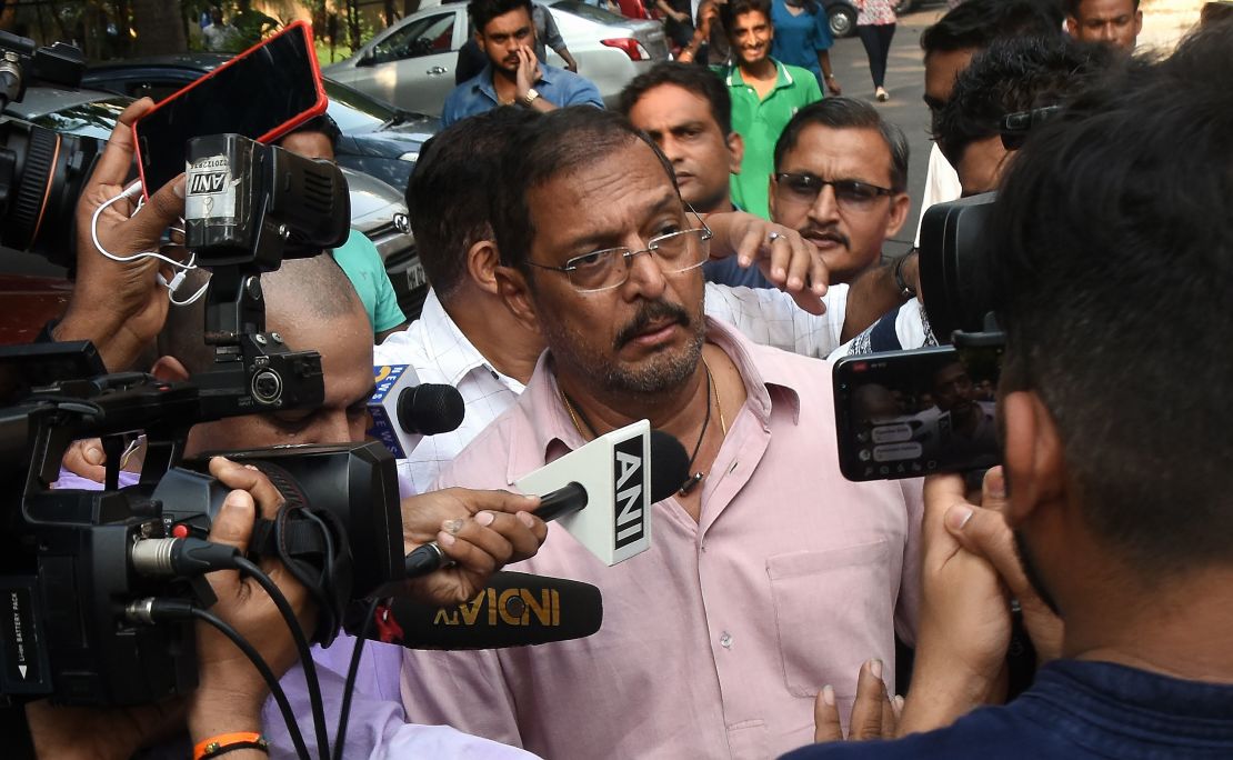 Indian Bollywood actor Nana Patekar is mobbed by the media as he leaves after making a statement outside his home in Mumbai on October 8, 2018. 