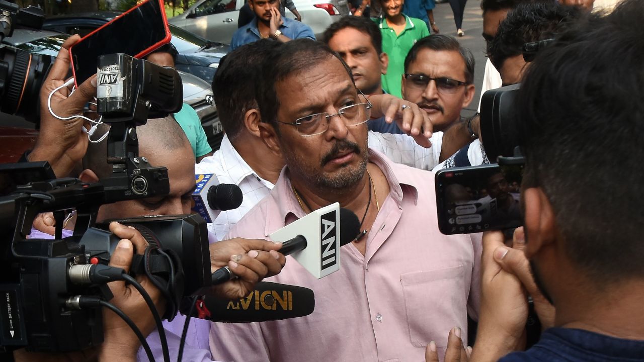 Indian Bollywood actor Nana Patekar is mobbed by the media as he leaves after making a statement outside his home in Mumbai on October 8, 2018.