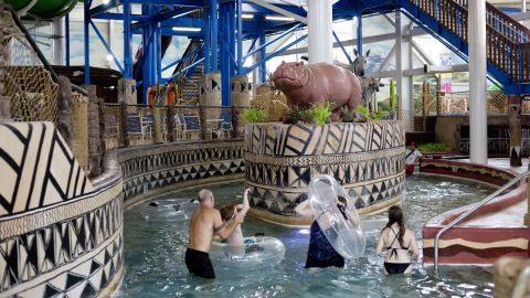 A group of visitors get out of their inflatable tubes after riding the Lazy River at Kalahari's indoor water park.