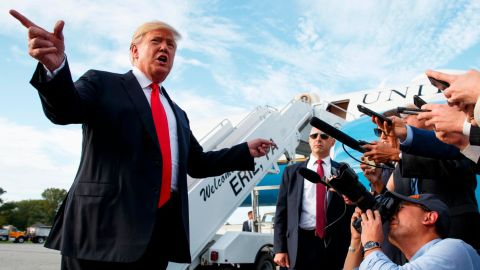 President Donald Trump talks with reporters after arriving at Erie International Airport for a campaign rally at Erie Insurance Arena, Wednesday, Oct. 10, 2018, in Erie, Pa. (AP Photo/Evan Vucci)