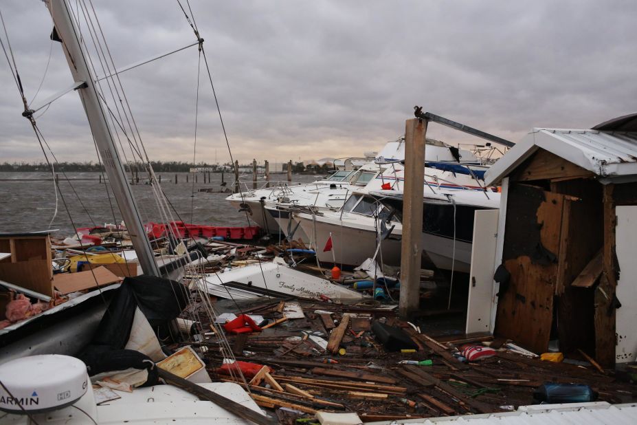 Wrecked boats sit near a pier in Panama City.