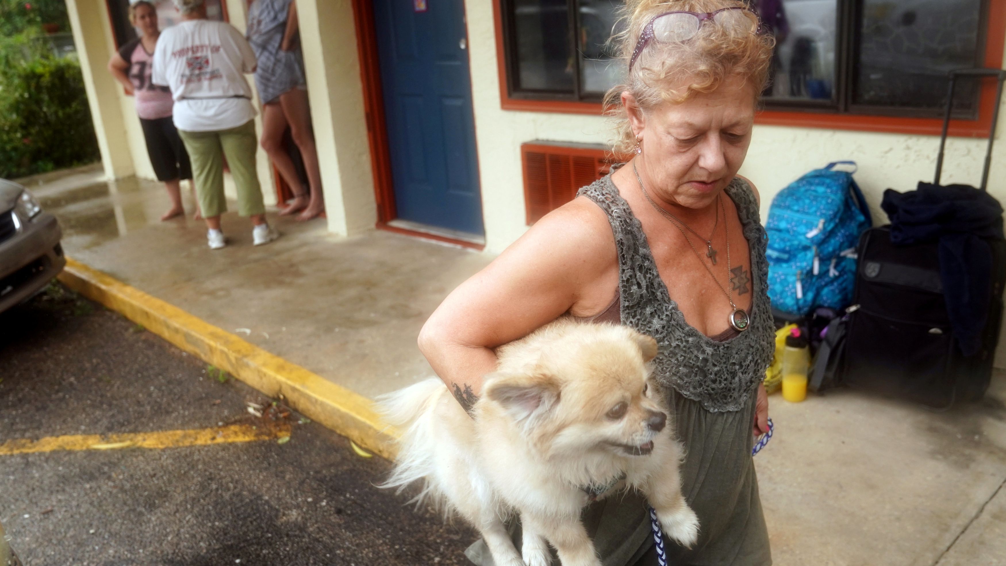 Lenora Adams evacuates a motel with her dog as the hurricane comes ashore in Panacea, Florida, on October 10. 