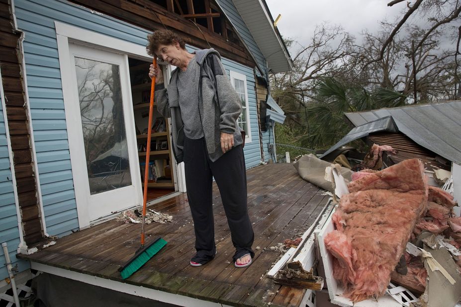 Phlomena Telker stands on the remains of her covered porch in Panama City.