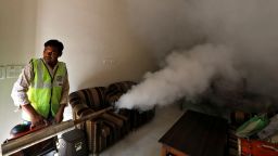 A public health department worker fumigates inside a house to prevent the spread of mosquito borne diseases in New Delhi, India, October 9, 2018. 