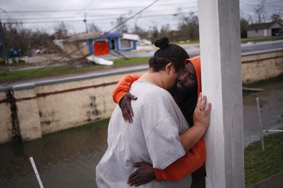 People comfort each other outside an apartment building in Panama City.