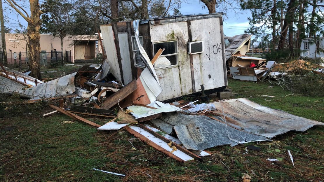 Debris is piled up near a destroyed mobile home. Michael's 150-mph winds damaged many buildings in the area.