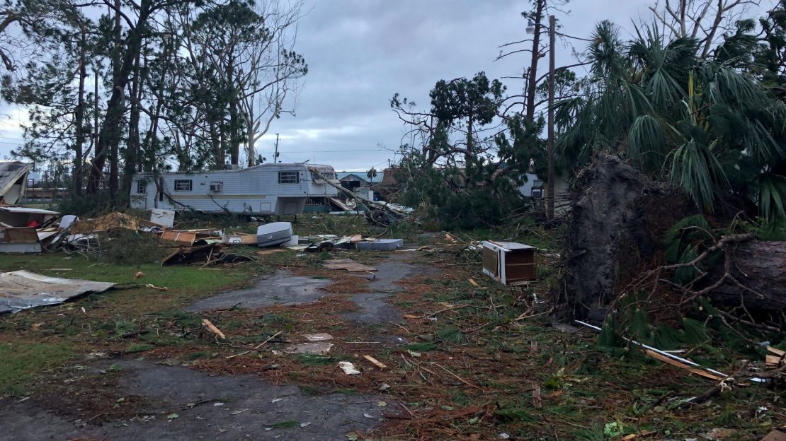 Downed trees and debris litter the mobile home park in Panama City.