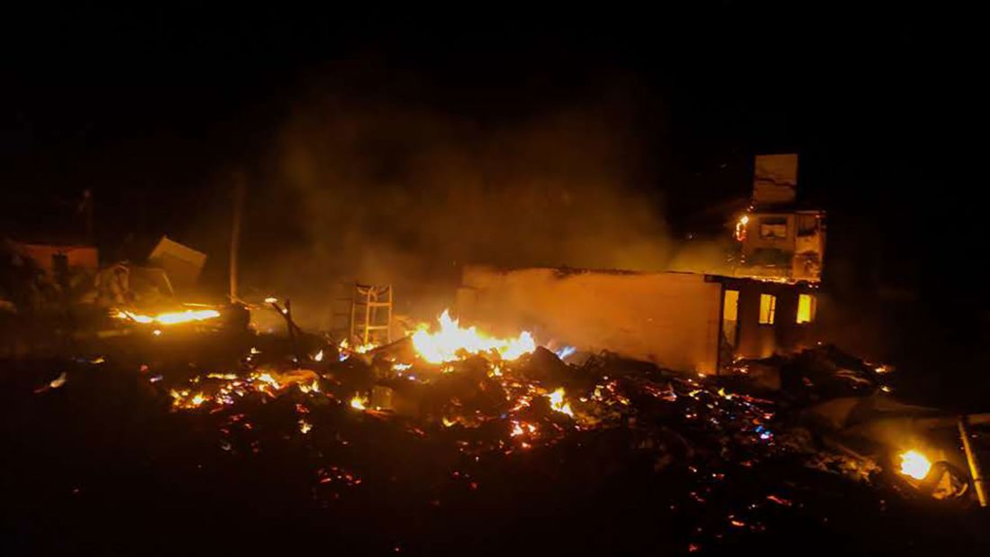 Debris burns in Mexico Beach on October 11.