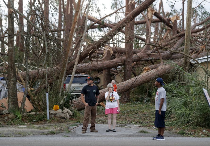 Joyce Fox stands in front of her heavily damaged home in Panama City on October 11.