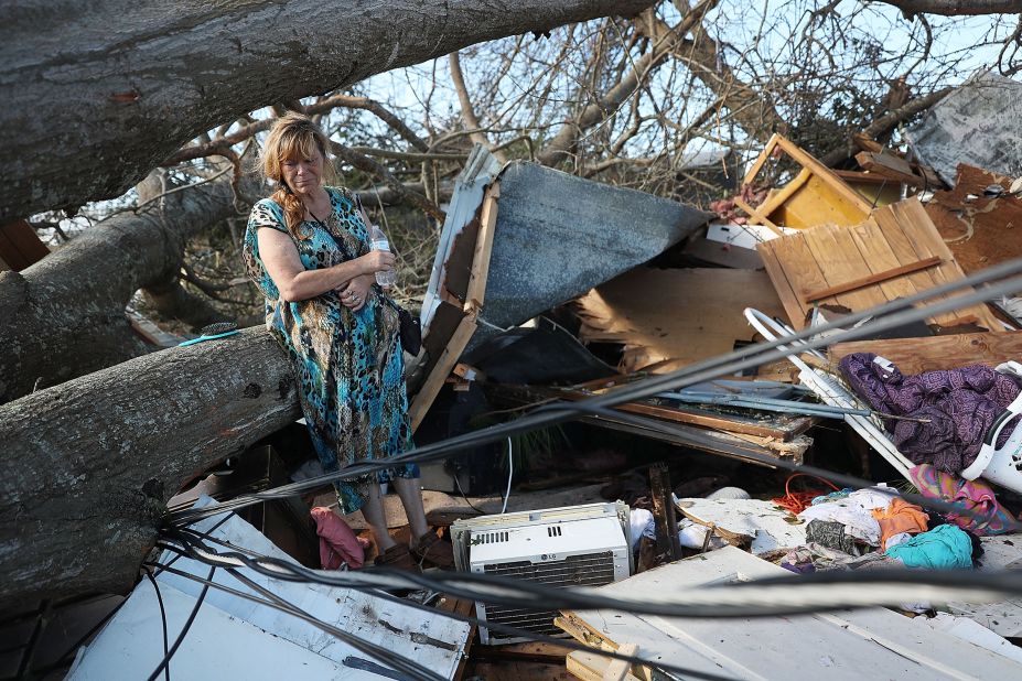 Kathy Coy stands among what is left of her home in Panama City. She said she was in the home when it was blown apart and is thankful to be alive.