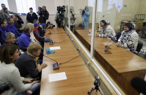 Hague and Ovchinin speak with their relatives through safety glass prior to the launch of Soyuz MS-10.