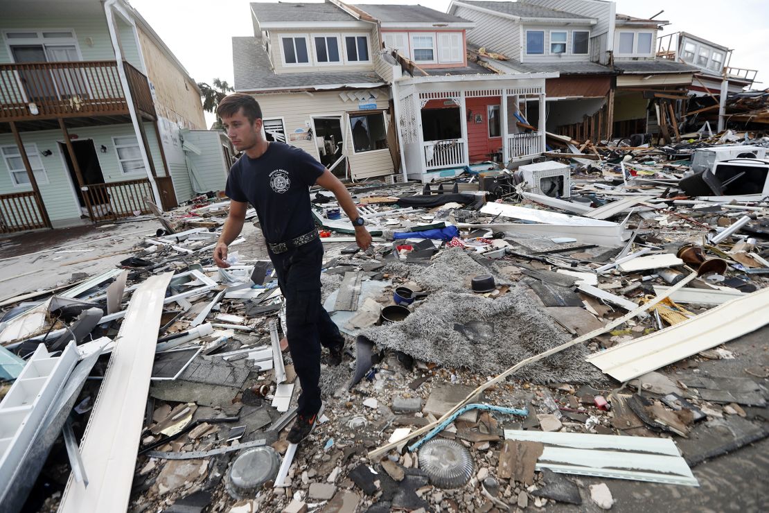 A firefighter searches door to door after Hurricane Michael in Mexico Beach.