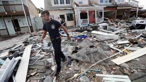 A firefighter searches door to door after Hurricane Michael in Mexico Beach.