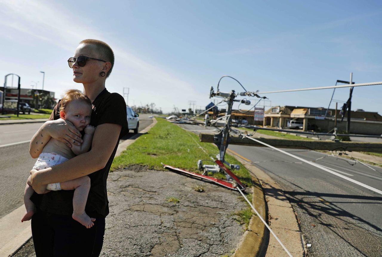 Kylie Strampe holds her 4-month-old daughter, Lola, while surveying the damage in Callaway, Florida, on October 11.