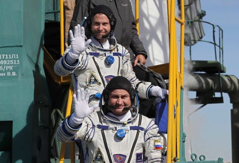 US astronaut Nick Hague, back, and Russian cosmonaut Alexey Ovchinin board the rocket prior to launch.