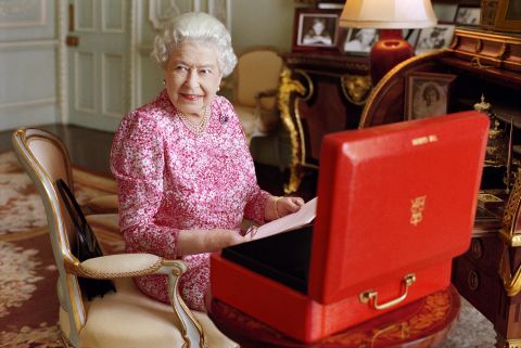 The Queen is seated at her desk in her private audience room at Buckingham Palace in July 2015. She is seen with one of her official red boxes, which contains important papers from government ministers in the United Kingdom and from representatives across the Commonwealth and beyond. The photo was taken to mark the moment the Queen became the longest-reigning British monarch.