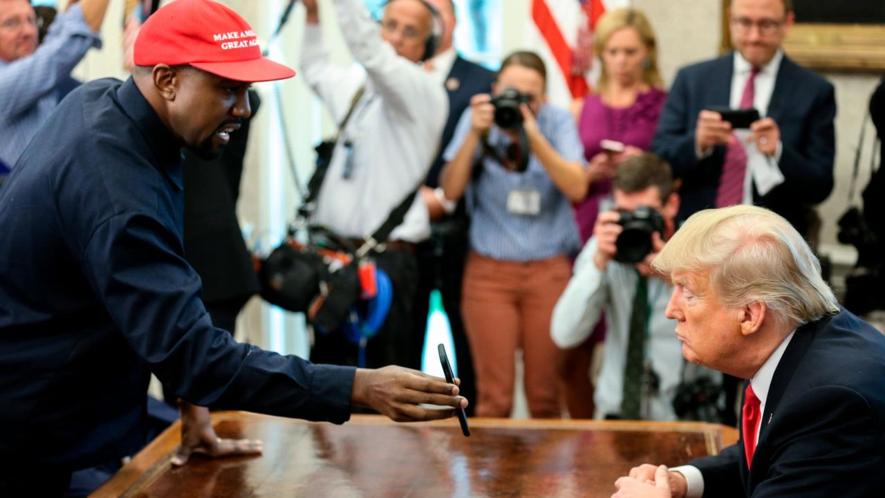 Rapper Kanye West , left, shows a picture of a plane on a phone to U.S. President Donald Trump during a meeting in the Oval office of the White House on October 11, 2018 in Washington, DC.