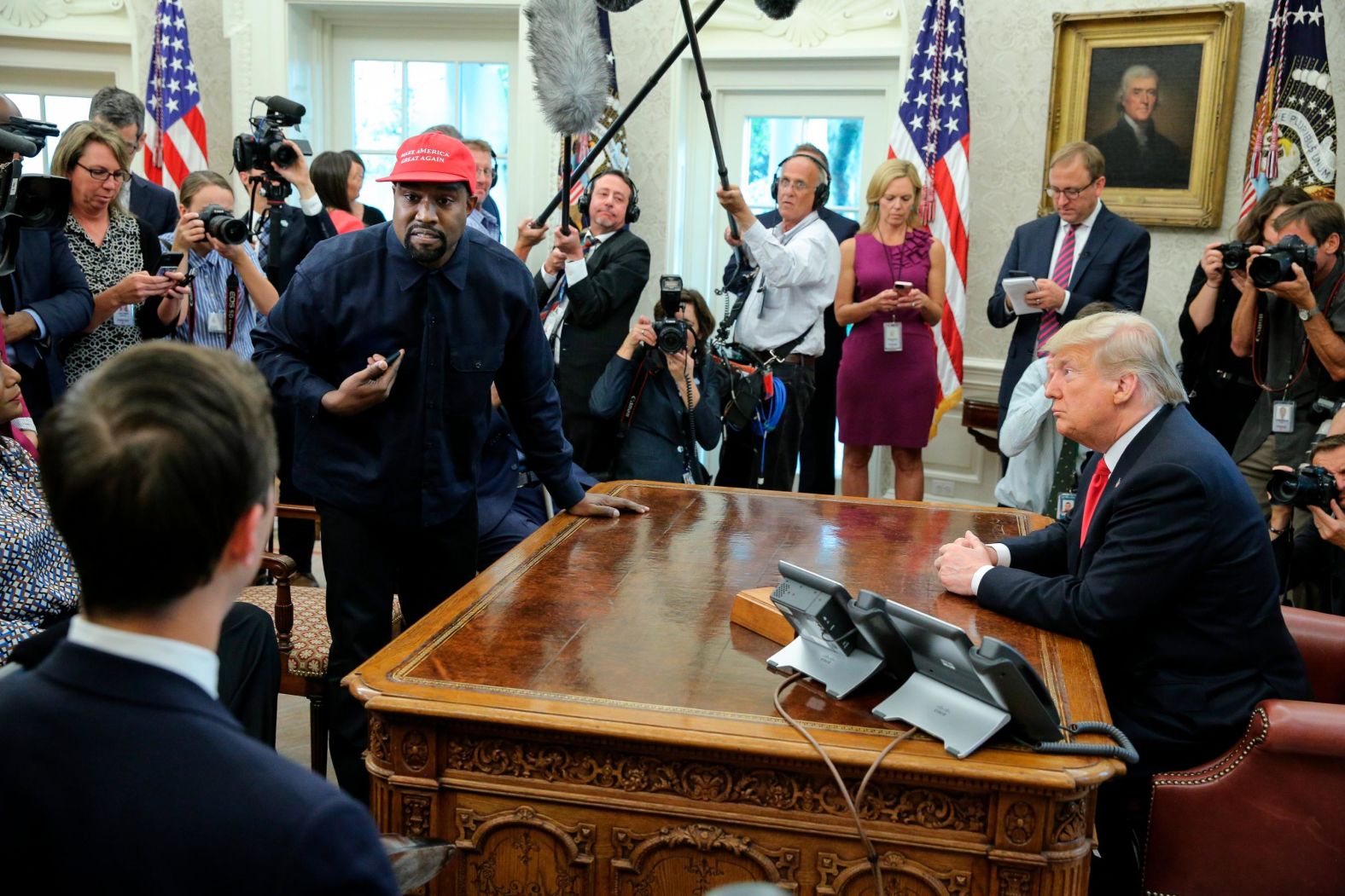 Rapper Kanye West stands up during his Oval Office meeting with Trump in October 2018. West and football legend Jim Brown <a href="index.php?page=&url=https%3A%2F%2Fwww.cnn.com%2F2018%2F10%2F11%2Fpolitics%2Fkanye-west-donald-trump-white-house-chicago%2Findex.html" target="_blank">had been invited for a working lunch</a> to discuss topics such as urban revitalization, workforce training programs and how best to address crime in Chicago. 