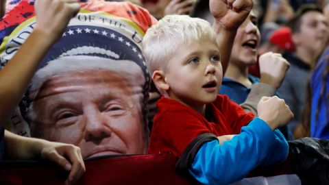 A child watches as President Donald Trump holds a campaign rally in Council Bluffs, Iowa, October 9, 2018.