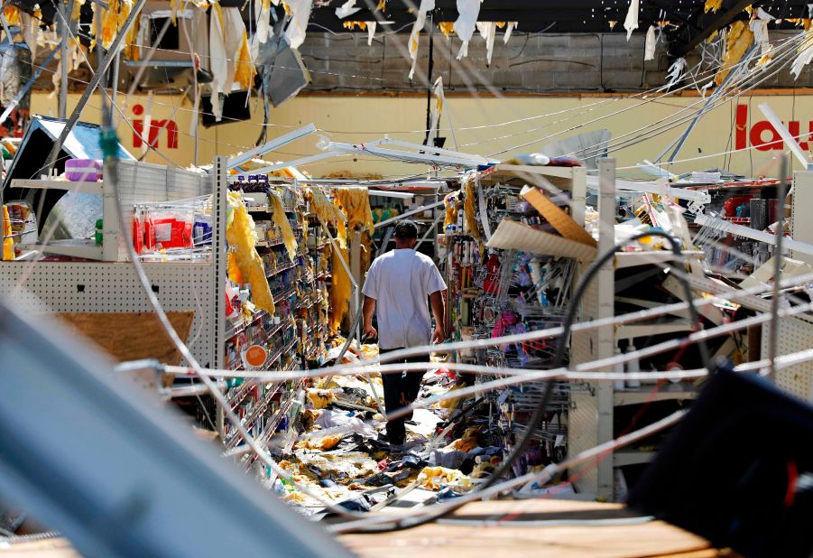 A man walks through a damaged store in Springfield, Florida.