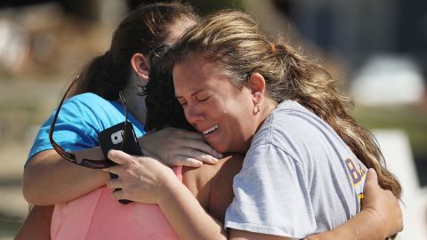 Elizabeth Hanson, right, and daughter Emaly hug their neighbor Cindy Clark in Mexico Beach.
