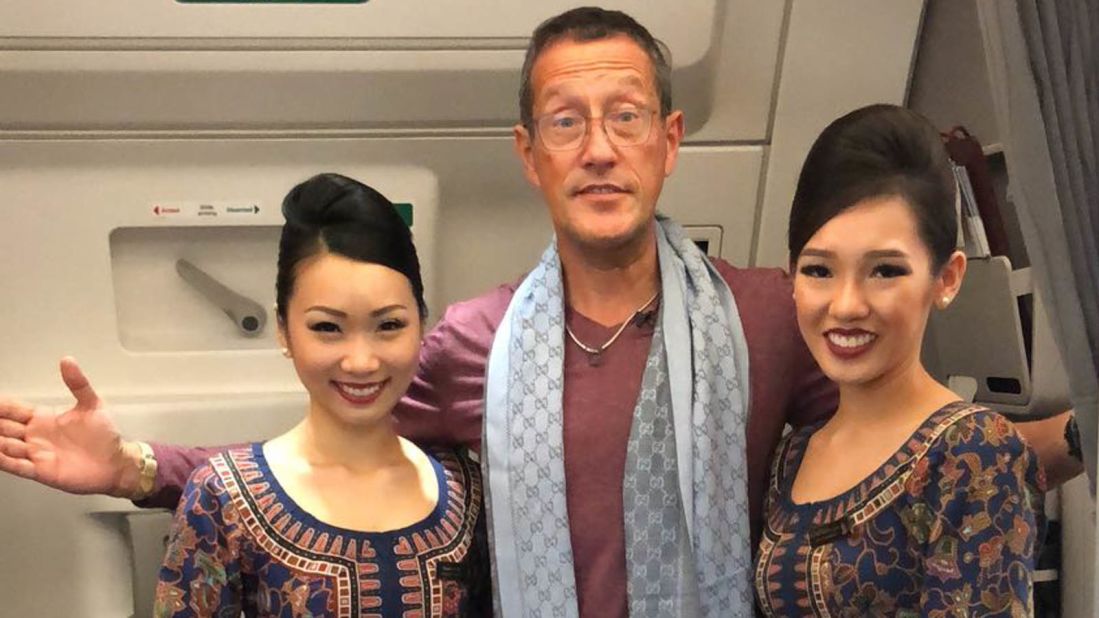 <strong>October: </strong>Richard Quest poses with Singapore Airlines cabin crew aboard the history-making world's longest flight, shortly before landing.