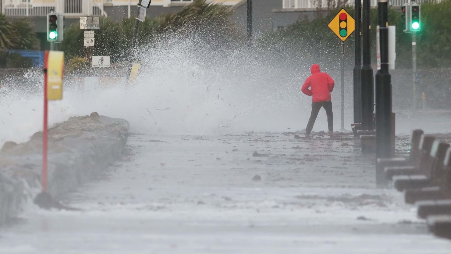 A man avoids the waves at Salthill promenade, County Galway, Ireland, during Storm Callum.