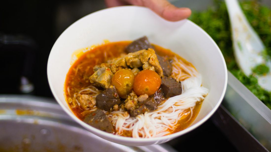 <strong>Khanom jeen naam ngiaw:</strong> Pork rib broth, dried chili-based curry paste, cubed blood and tomatoes, and thin, flat rice noodles make for a salty and savory, near ubiquitous local favorite. 