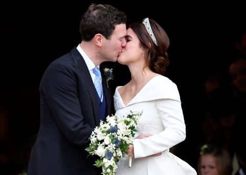Princess Eugenie and Jack Brooksbank kiss on the steps of St. George's Chapel.