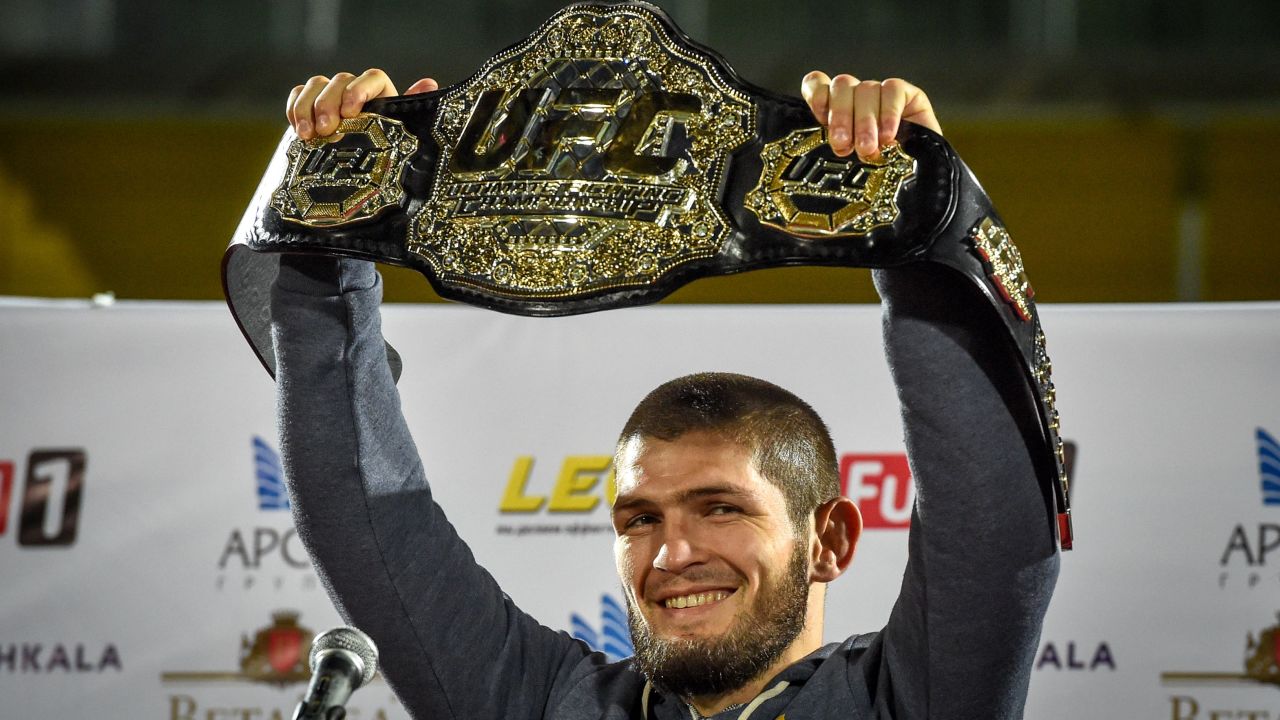 Nurmagomedov raises his belt upon his arrival back in Makhachkala, Russia, on October 8, after defeating McGregor in the fourth round of their title fight.