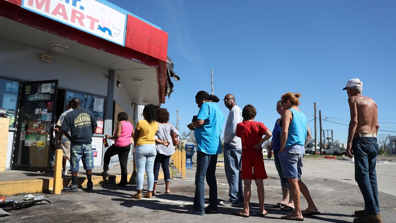 People line up Friday outside a Panama City convenience store in the aftermath of Hurricane Michael.