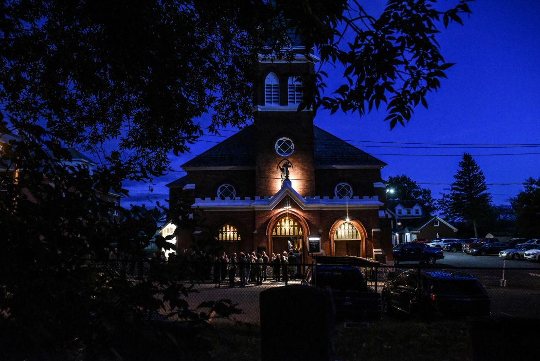 Mourners line up outside  St. Stanislaus Roman Catholic Church in Amsterdam, New York, to pay their respects to victims of last weekend's fatal limo crash.