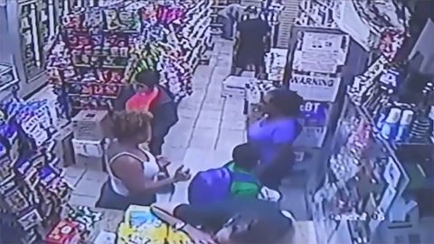 Surveillance video appears to show the boy's backpack brushing up against the woman's backside. 